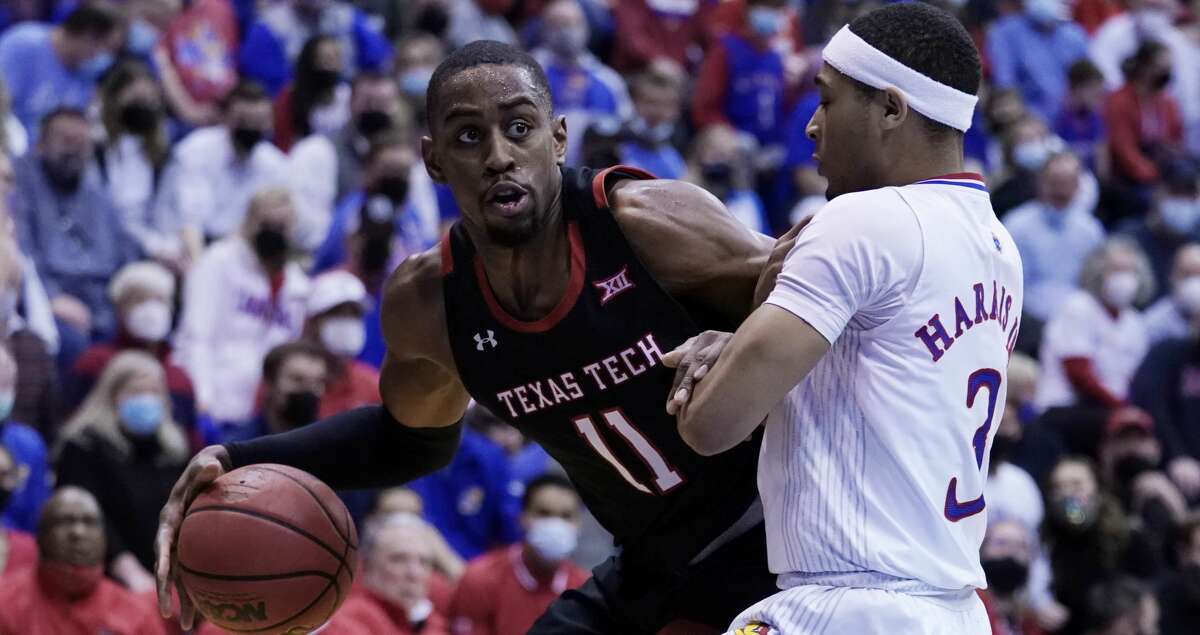 LAWRENCE, KANSAS - JANUARY 24: Bryson Williams #11 of the Texas Tech Red Raiders drives drives against Dajuan Harris Jr. #3 of the Kansas Jayhawks during the second half at Allen Fieldhouse on January 24, 2022 in Lawrence, Kansas. (Photo by Ed Zurga/Getty Images)