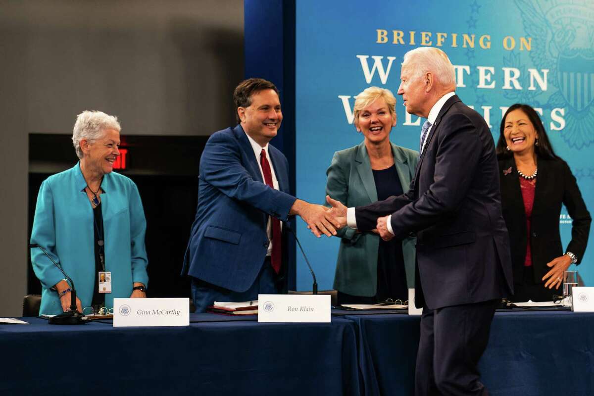 President Biden greets White House Chief of Staff Ron Klain before a meeting in June 2021. With them are, from left, climate coordinator Gina McCarthy, Energy Secretary Jennifer Granholm and Interior Secretary Deb Haaland.