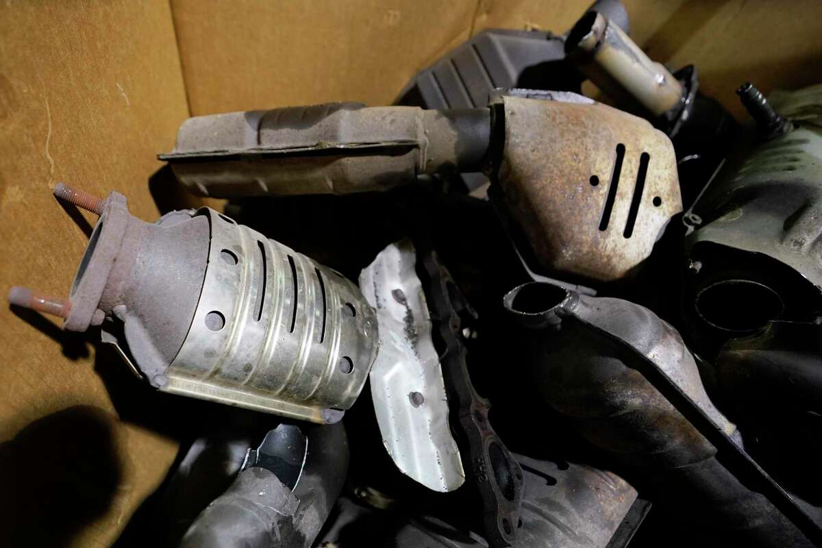 Used catalytic converter that was removed from cars at a salvage yard are piled up in a carton Friday Dec. 17, 2021, in Richmond, Va. (AP Photo/Steve Helber)