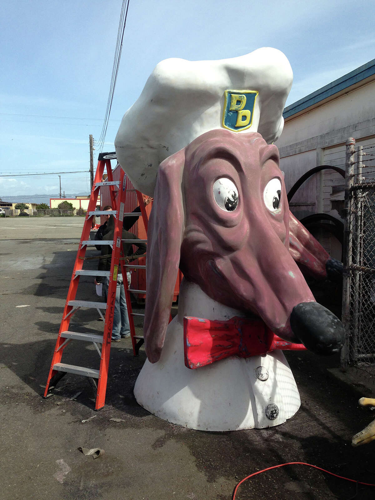 A Doggie Diner head dating back to the 1960s is prepared for the restoration process.  