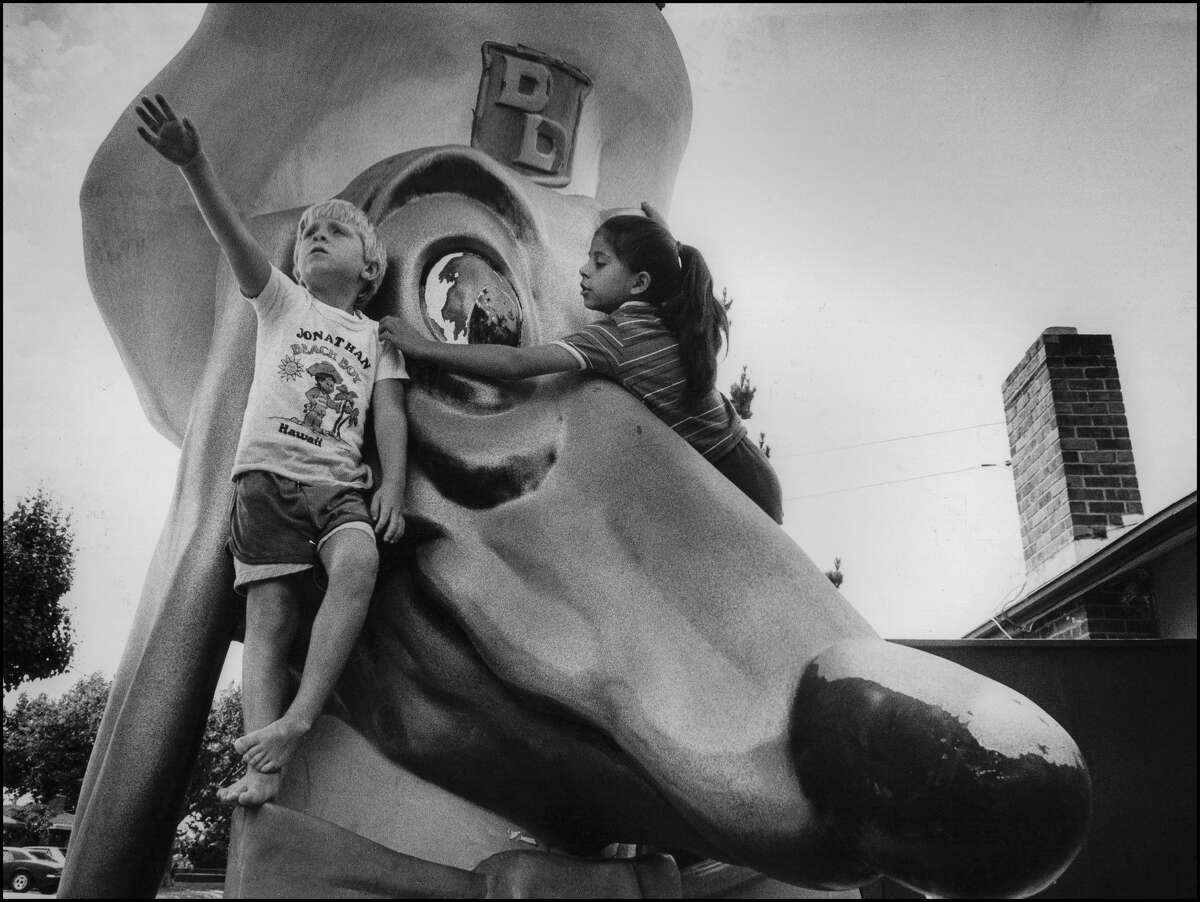 Two young children climb a fiberglass mascot outside a Doggie Diner restaurant in Hayward in 1985. 