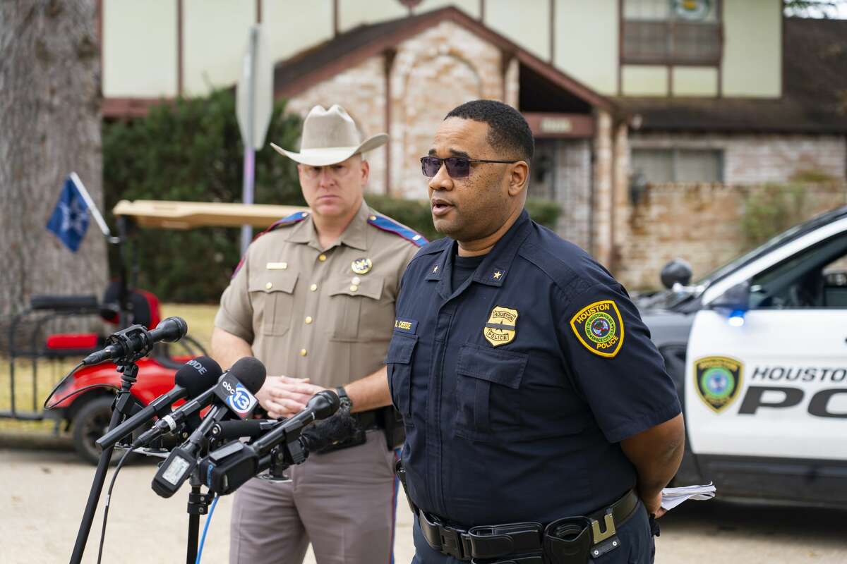 A press conference is held where law enforcement say they have been investigating the scene of a possible homicide at a white-columned house along Carolcrest Drive, Tuesday, Jan. 25, 2022, in west Houston. Police confirmed that the case may be related to 26-year-old Ryan Mitchell Smith who is on the run accused by police of stabbing a police K-9.