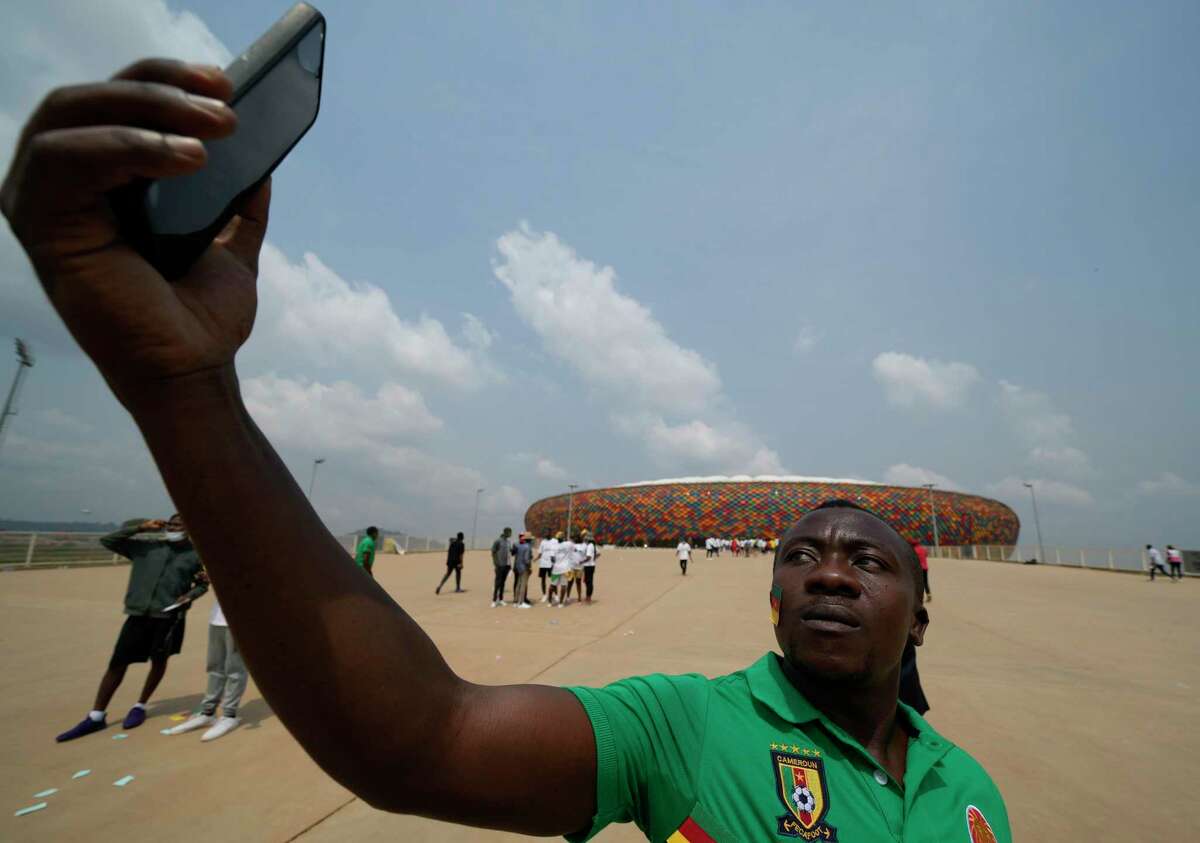 A soccer fan takes a selfie before the start of the Africa Cup Soccer 2022 group A soccer match between Cameroon and Burkina Faso at the Olembe stadium in Yaounde, Cameroon, Sunday, Jan. 9, 2022. (AP Photo/Themba Hadebe)