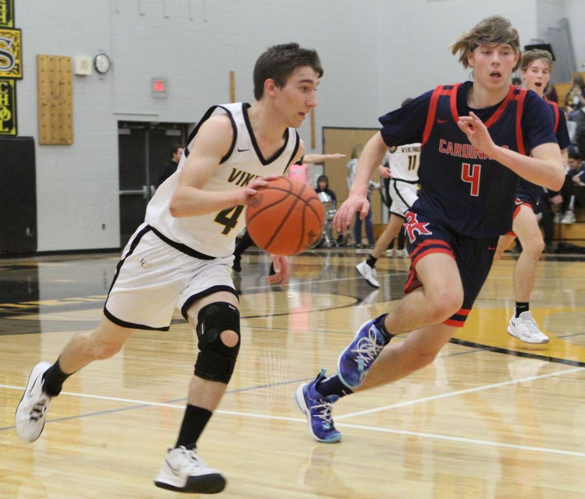 Tri County junior Brett Flintoff, left, paces up the court while defended by BR's Mason Dunn during Friday night.