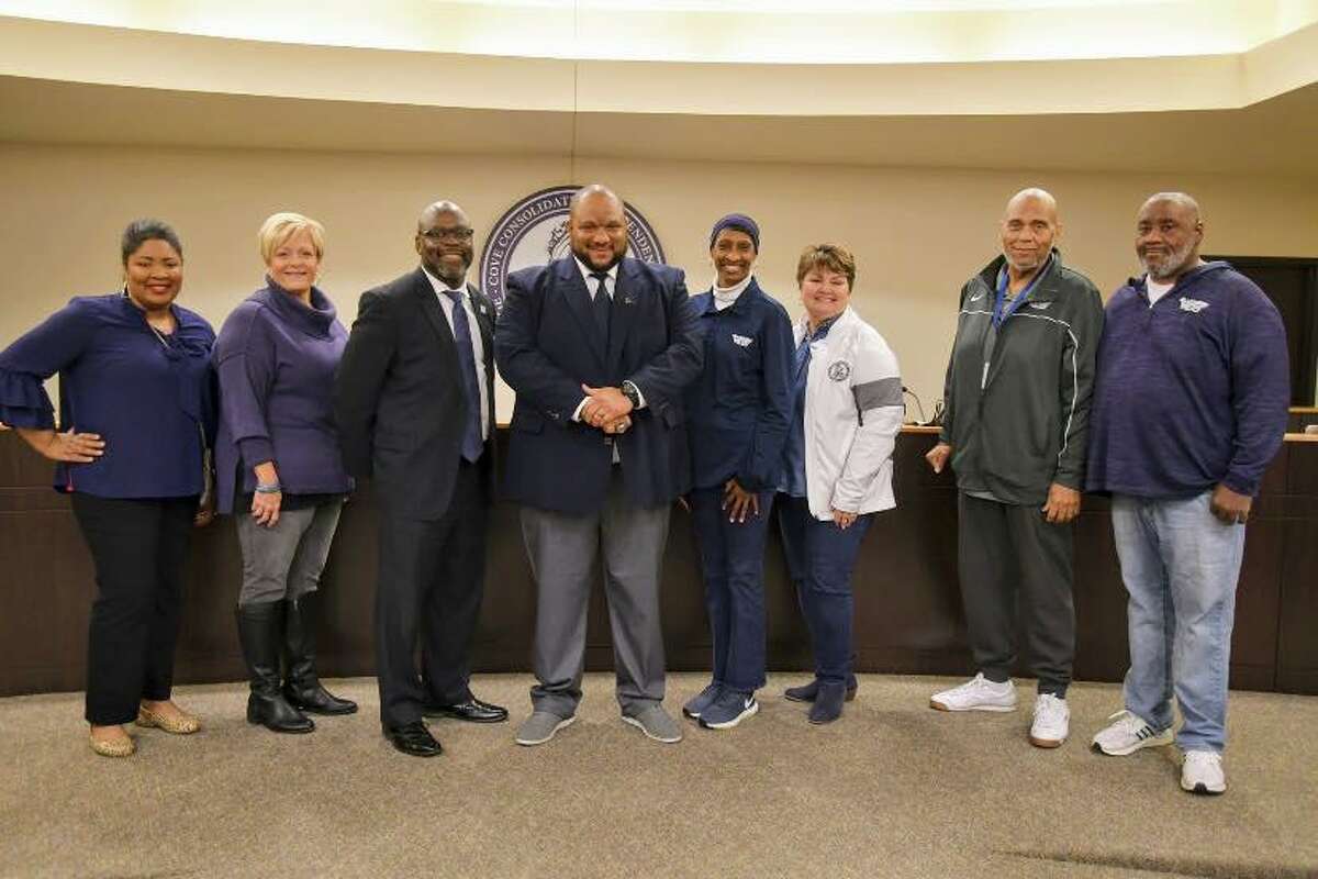 Hiawatha Hickman (middle) poses for a picture with the West Orange-Cove school board after a tense meeting on Monday night.