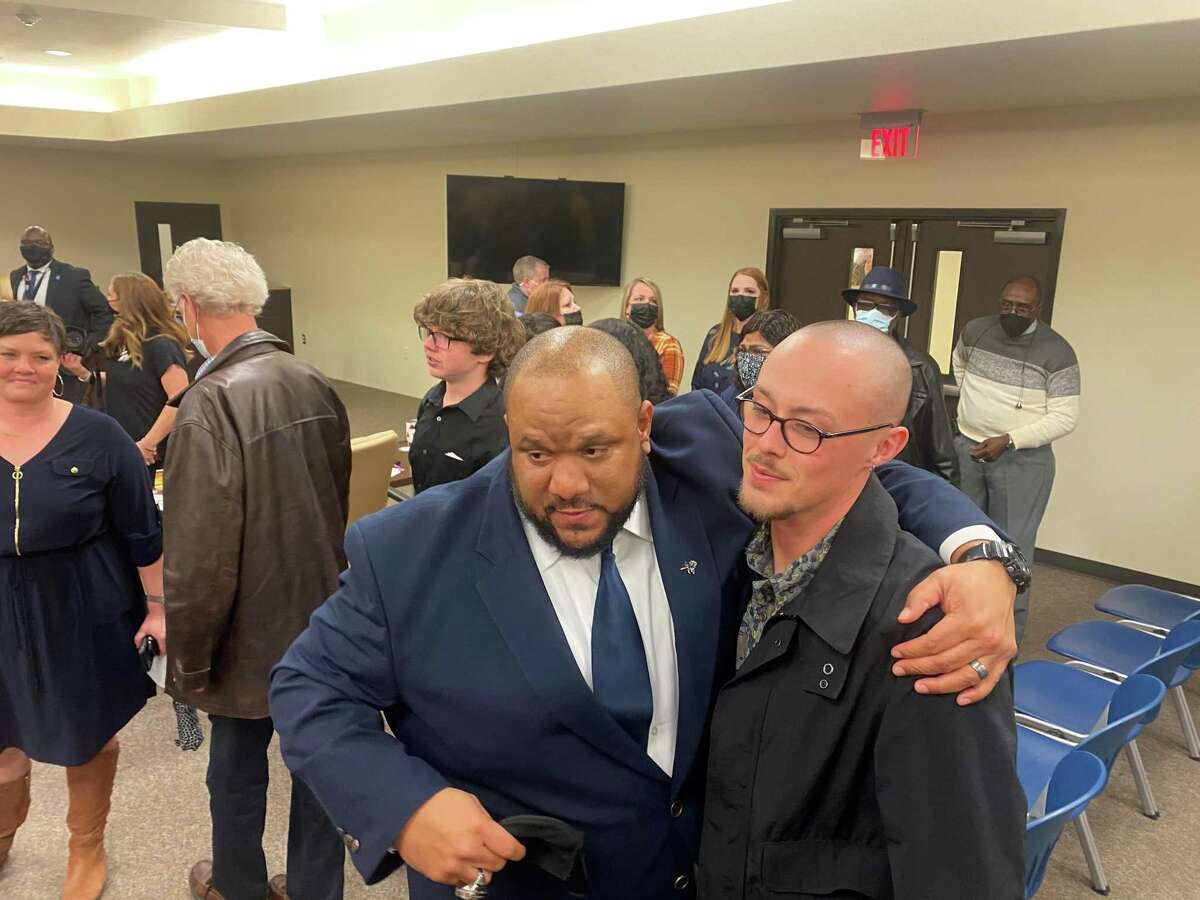 New WO-S head football coach Hiawatha Hickman hugs supporters after Monday night's board meeting.