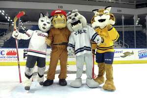 UConn’s Johnathan the Husky, Sacred Heart’s Big Red the Pioneer, Yale’s Boola the Bulldog and Quinnipiac’s Boomer the Bobcat, the four mascots from Connecticut universities participating in the Connecticut Ice gather on the ice at Webster Bank Arena, in Bridgeport, Conn. Dec. 16, 2019. The collegiate ice hockey tournament will be played at the arena in January.