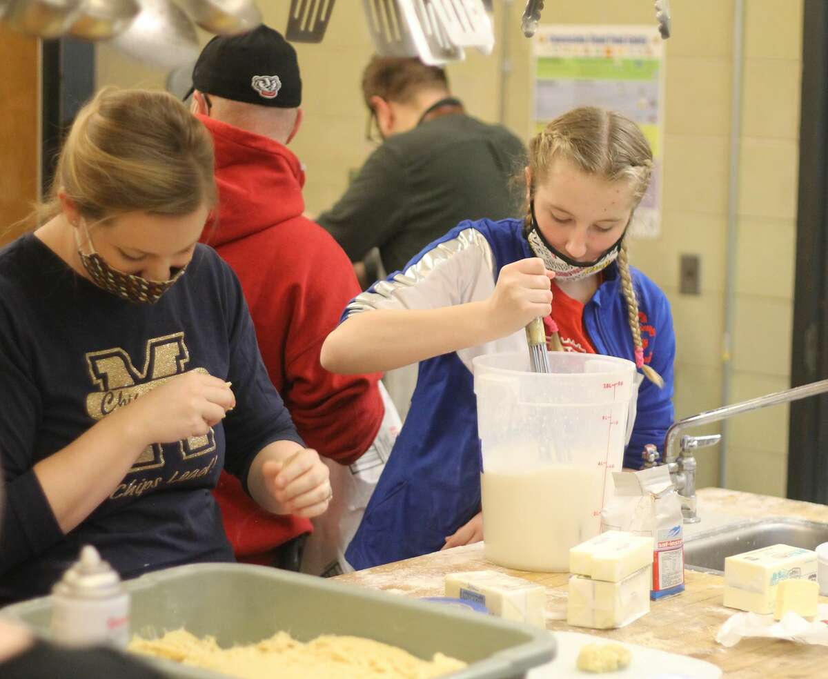 In this file photo, volunteers work on preparing the dough for the Manistee Catholic Central Athletic Association's paczki sale last year.