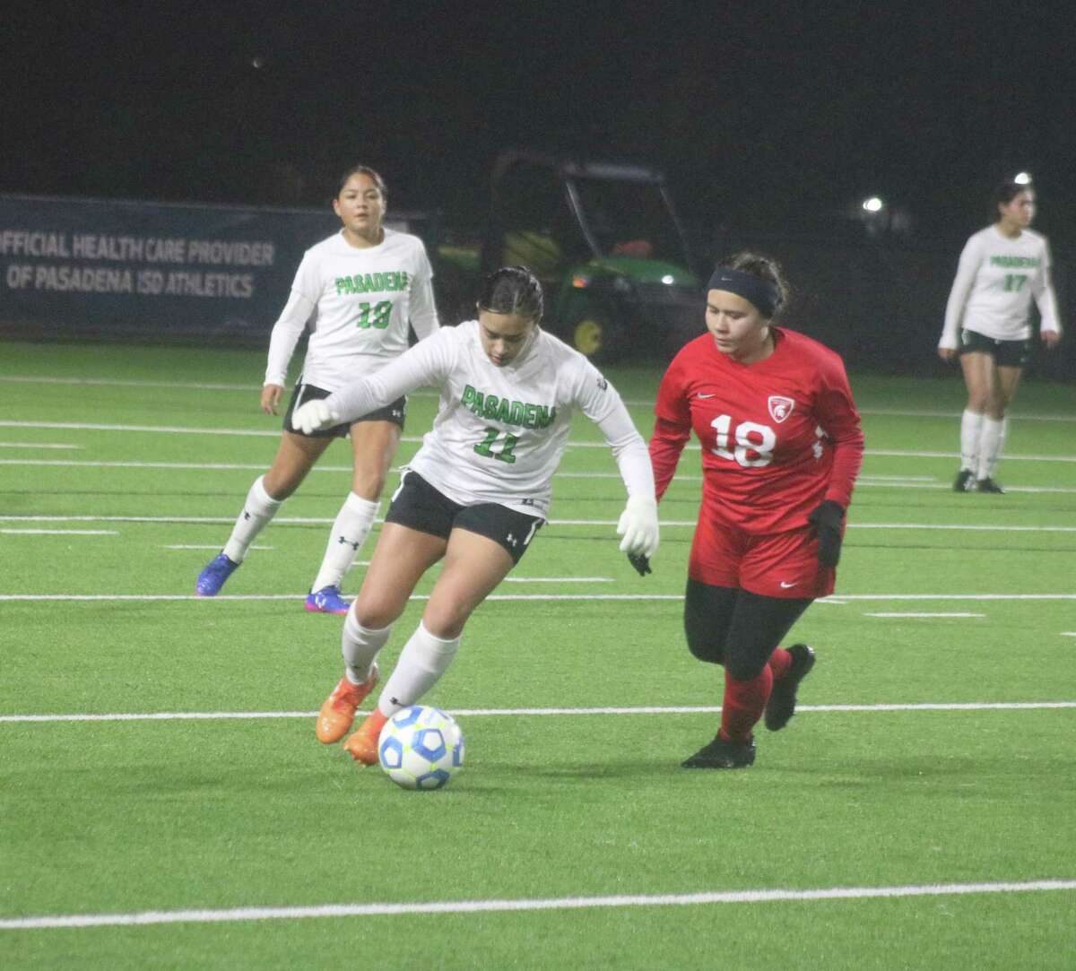 A Lady Eagles attempts to advance the ball up the field during first-half action Monday night at Veterans Memorial Stadium.