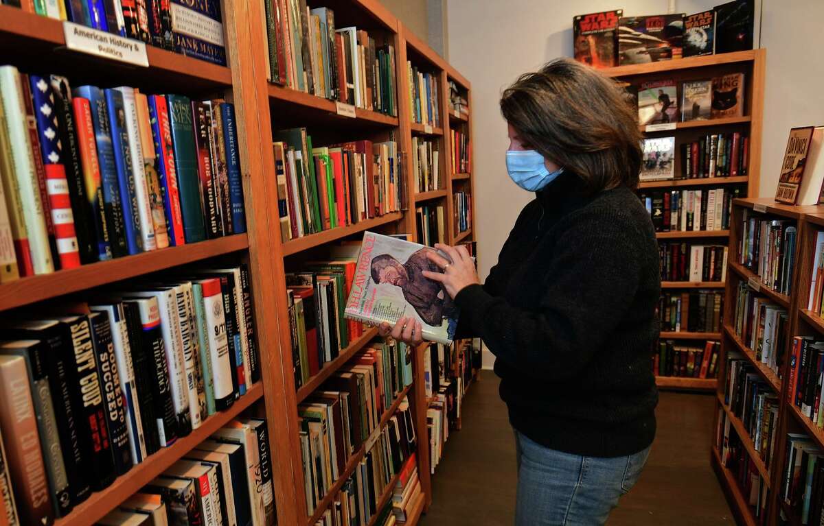 President of Westport Book Sale Ventures Jocelyn Barandiaran organizes books at The Westport Book Shop, the first used book shop in town Tuesday, January 16, 2021, in Westport, Conn.