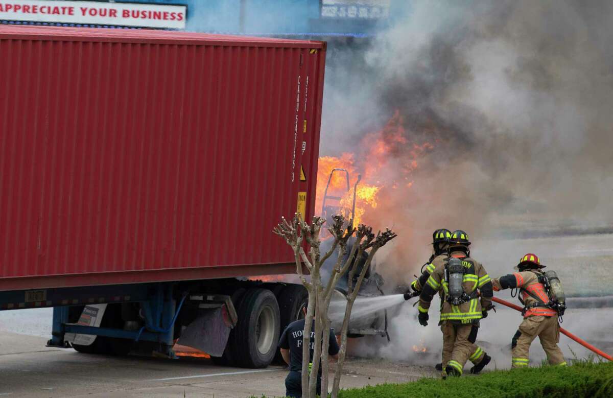 Houston firefighters putting out fire on an 18-wheeler on West 34th Street near Watonga Boulevard Tuesday, Jan. 25, 2022, in Houston.
