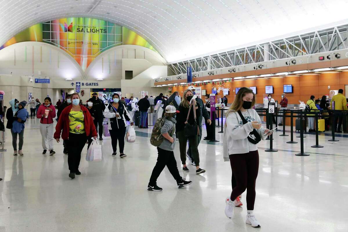 Passengers head to the TSA checkpoint in Terminal A at the San Antonio International Airport, Monday, Jan. 3, 2022.