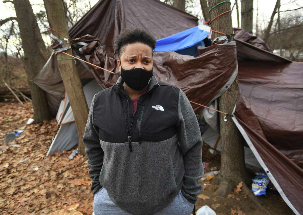 Samm Williams, right, an outreach case manager with Open Door Shelter, checks on the encampment of a homeless couple during an afternoon of canvassing the city homeless population in Norwalk, Conn. on Tuesday, January 25, 2021.