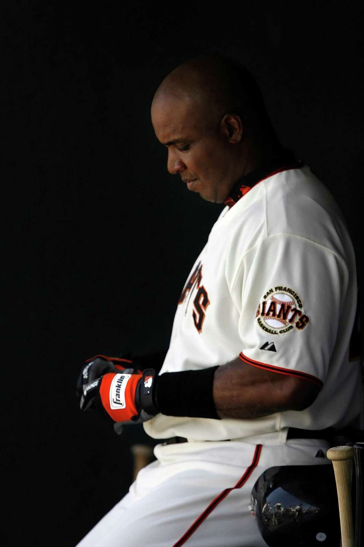 GIANTS20_013_CAG.JPG Barry Bonds waits to enter the game as a pinch hitter on Wednesday, July 19, 2006, during the final innings in the Giants' dugout. Bonds could be indicted as soon Thursday on federal charges of perjury and tax evasion. The San Francisco Giants played the Milwaukee Brewers at AT&T Park in San Francisco, Ca., on Wednesday, July 19, 2006. Photo by Carlos Avila Gonzalez/The San Francisco Chronicle Photo taken on 7/19/06, in San Francisco, Ca, USA **All names cq (Roster)