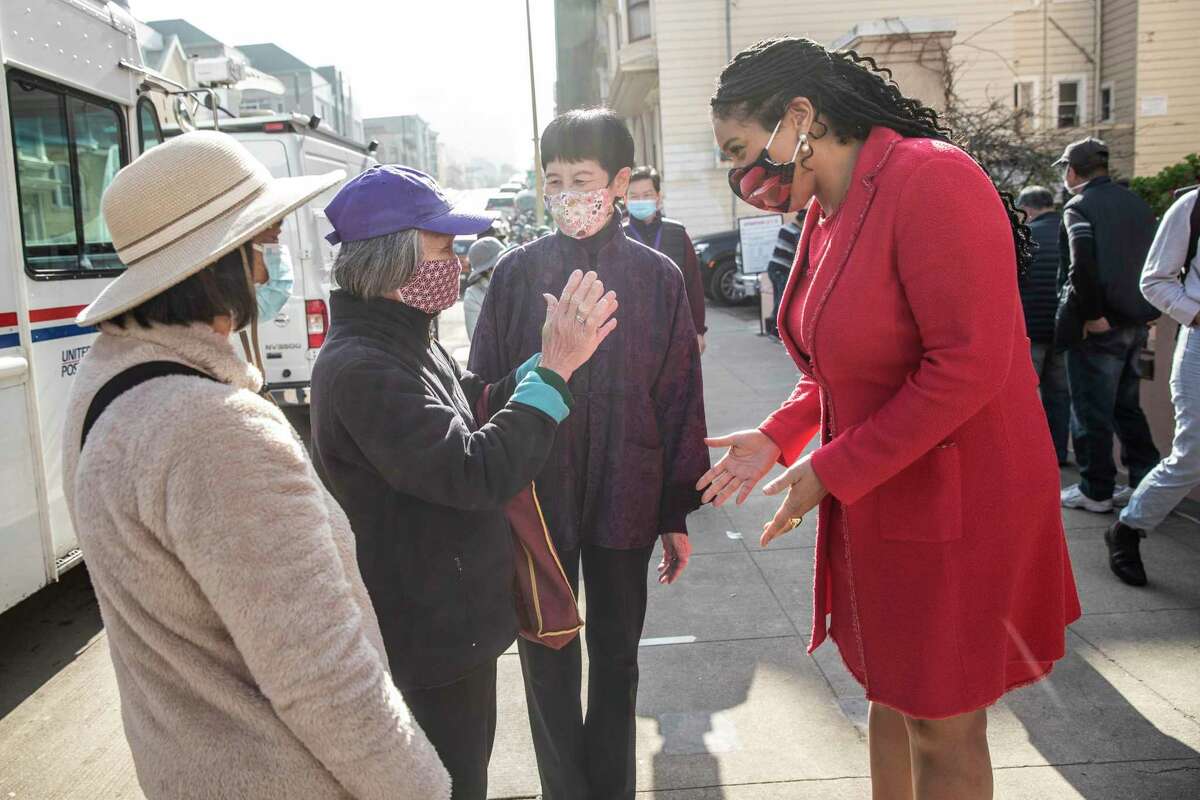 San Francisco Mayor London Breed (right) greets a well-wisher after a press conference on the city’s 2021 hate crime statistics and public safety strategy for 2022 at Lady Shaw Senior Center in the Chinatown neighborhood of San Francisco.