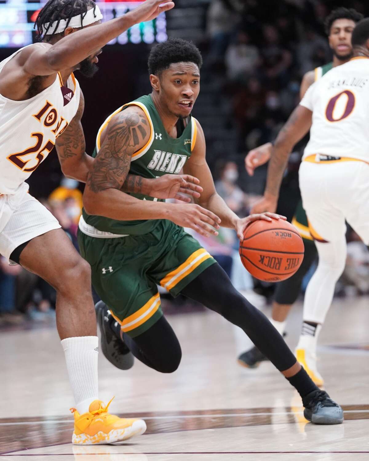 Siena's Colby Rogers drives against Iona's Tyson Jolly (25) during their game on Tuesday, January 25, 2022. Rogers led the Saints with 17 points.