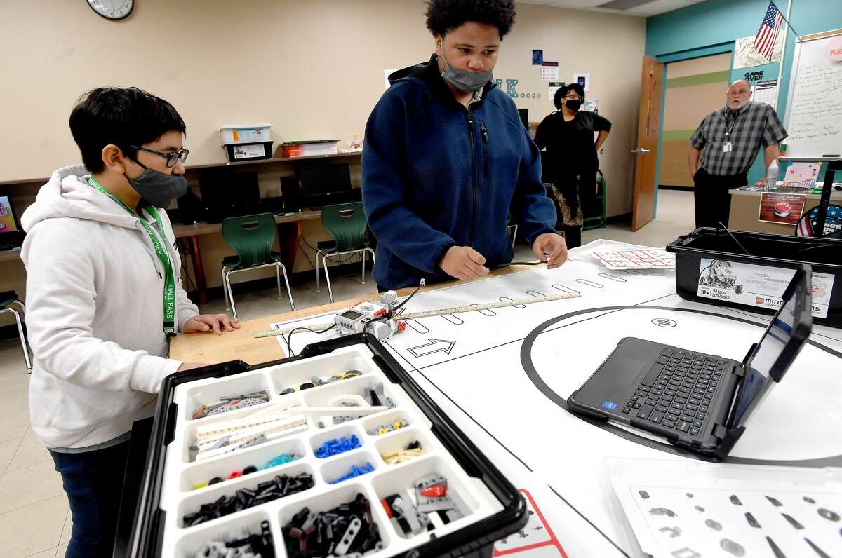 Samuel Escuadra (left) and Bryson Tyler work on a robotics project during Benjamin Cassell's e-sports class as Principal Audrey Collins observes at Pietzsch-MacArthur Pre-K - 8 Center. The newly expanded campus is now offering extracurriculars that it hasn't in years past, including band, theater and e-sports. Photo made Tuesday, January 25, 2022 Kim Brent/The Enterprise