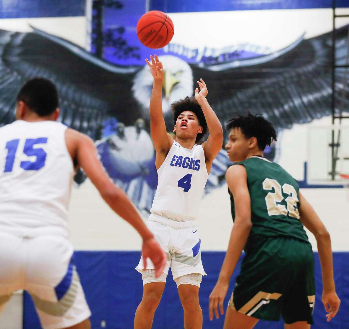 New Caney point guard Dylan Dempsey (4) shoots a three-pointer during a high school basketball game at New Caney High School, Tuesday, Dec. 28, 2021, in New Caney/