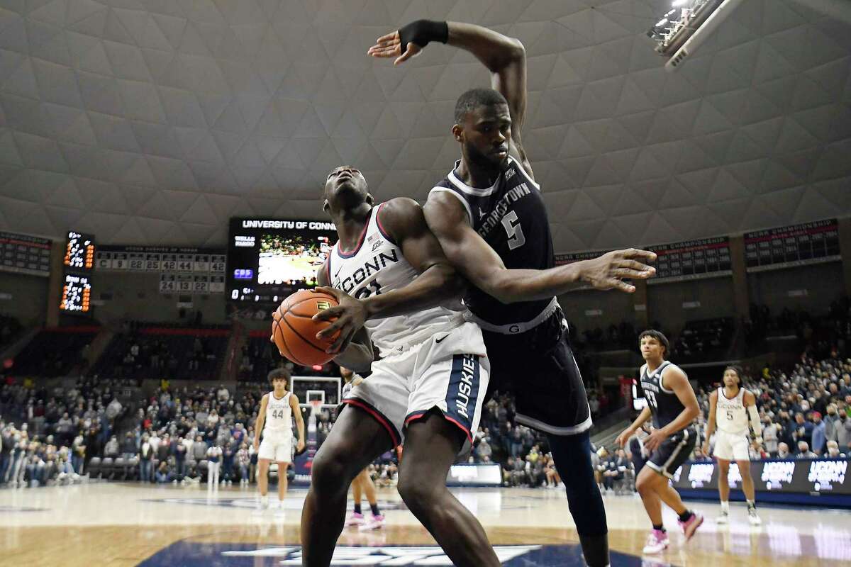UConn’s Adama Sanogo looks to shoot as Georgetown’s Timothy Ighoefe (5) defends in the first half of an NCAA college basketball game, Tuesday, Jan. 25, 2022, in Storrs, Conn.