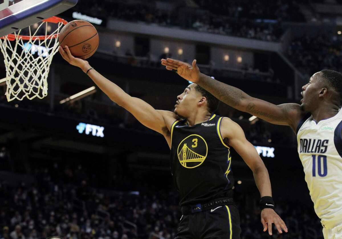 Jordan Poole (3) gets to the basket ahead of Dorian Finney-Smith (10) in the first half as the Golden State Warriors played the Dallas Mavericks at Chase Center in San Francisco, Calif., on Tuesday, January 25, 2022.