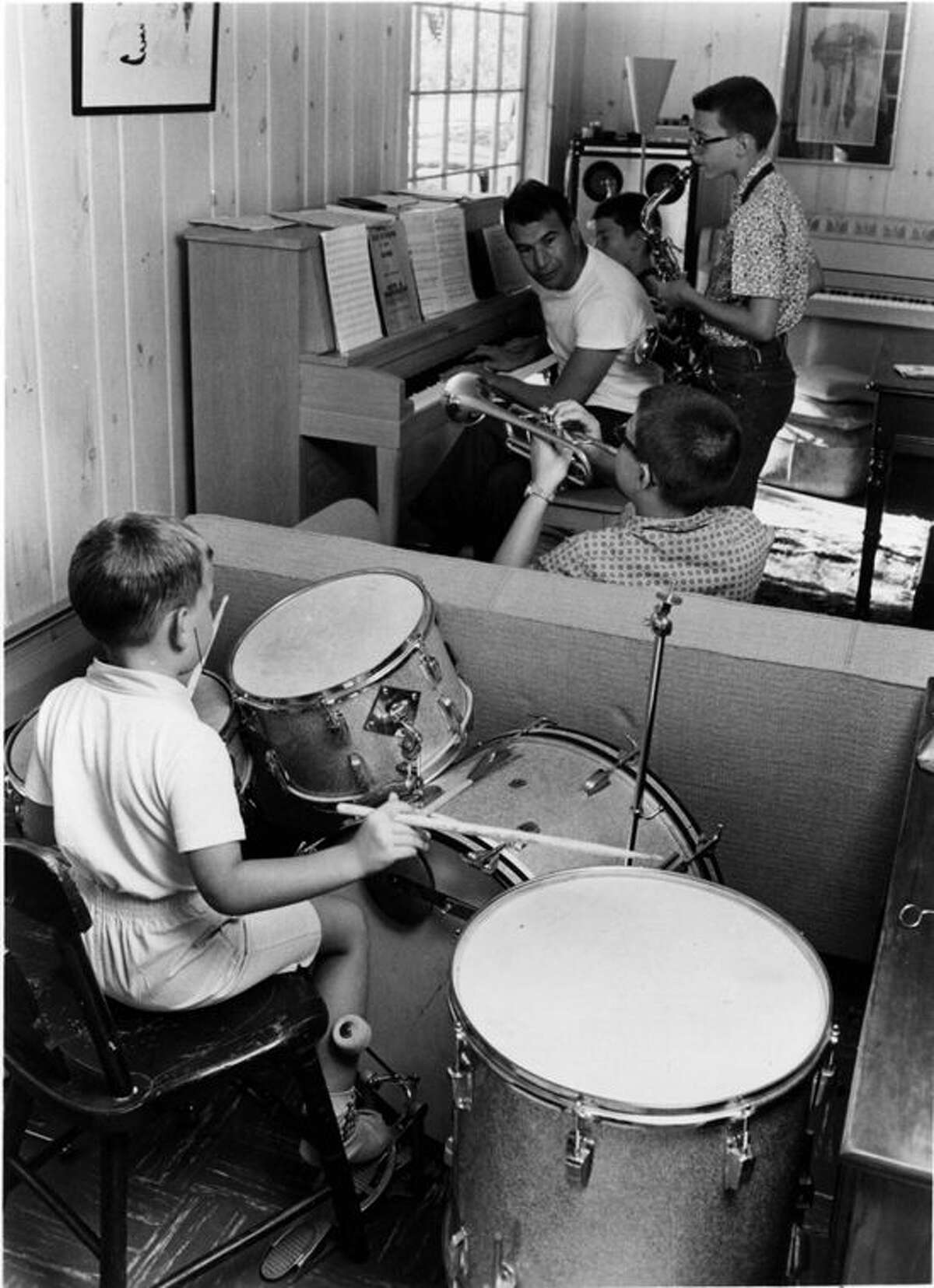 Little Dan on drums; Chris is on the piano bench with his Dad.  brothers Mike on sax and Darius on trumpet.