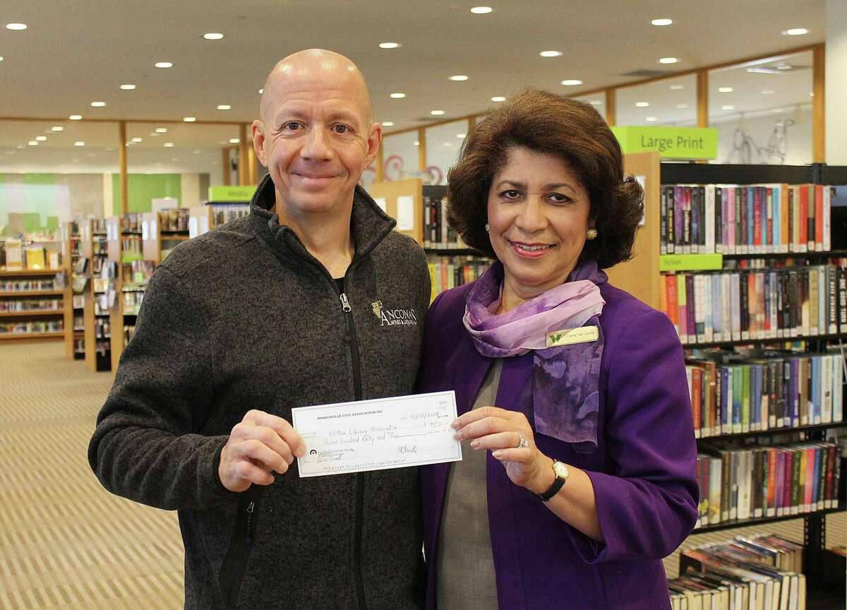 Mitch Ancona of Ancona’s Wines & Liquors in Wilton, and Ridgefield previosuly presents Wilton Library Executive Director Elaine Tai-Lauria with a check for $750 for the Wilton Library’s Bocce Brawlers team second place finish in the Branchville Civic Association’s 4th annual bocce tournament in a recent year. One of the upcoming events with the library is a special performance titled: “Watch the Amazing Acrobatics of Li Liu,” on Saturday, Feb. 5, from 11 to 11:45 a.m., to celebrate Take Your Child to the Library Day, and the Lunar New Year, with Ancona being the sponsor for the performance.