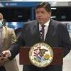 Gov. J.B. Pritzker, right, announced millions of dollars in state grants for America's Central Port in Granite City, Madison County Transit and Macoupin County on Wednesday morning. With him, at left, is Illinois Department of Transportation Director Omer Osman. 