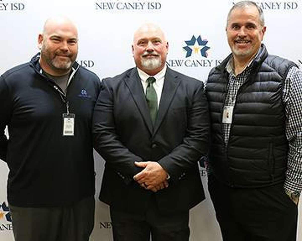 New Caney ISD Superintendent Matt Calvert, left, and New Caney ISD Athletic Director Jim Holley, right, join new West Fork High School Athletic Director/Head Football Coach Dougald McDougald for a photo.