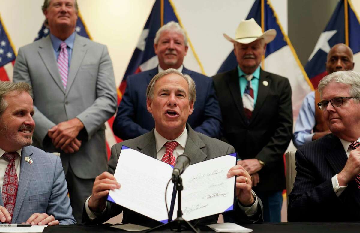 Gov. Greg Abbott signs Senate Bill 1 on Sept. 7. The new law has created needless obstacles to mail-in ballots.