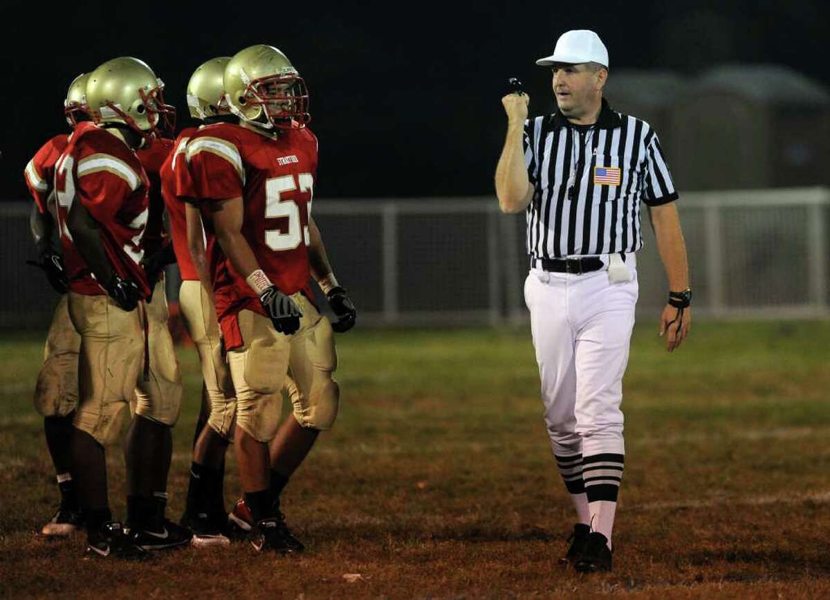 Greg Sperling calls a facemask foul as he officiates as head referee at the football game between Stratford High School and New Milford High School on Friday, September 24, 2010.