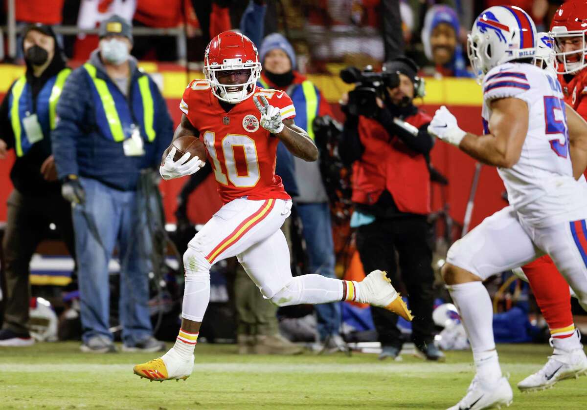Kansas City Chiefs wide receiver Tyreek Hill (10) heads toward the end zone to score on a 64-yard pass during the second half of an NFL divisional round playoff football game against the Buffalo Bills on Sunday.