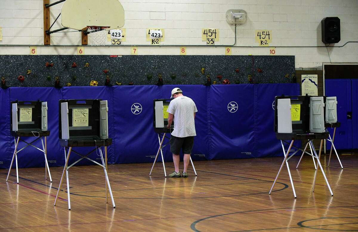 Voters cast their ballots at the polls in Norwalk on Sept. 14, 2021.