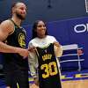 Jayda Curry poses with Stephen Curry, whose number she wears while playing at Cal, holding his jersey after the Golden State Warriors played Dallas Mavericks at Chase Center in San Francisco, Calif., on Tuesday, January 25, 2022.