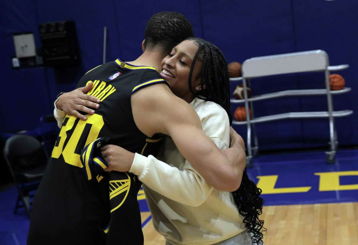 Jayda Curry gets a hug from Stephen Curry, whose number she wears while playing at Cal after the Golden State Warriors played Dallas Mavericks at Chase Center in San Francisco, Calif., on Tuesday, January 25, 2022.