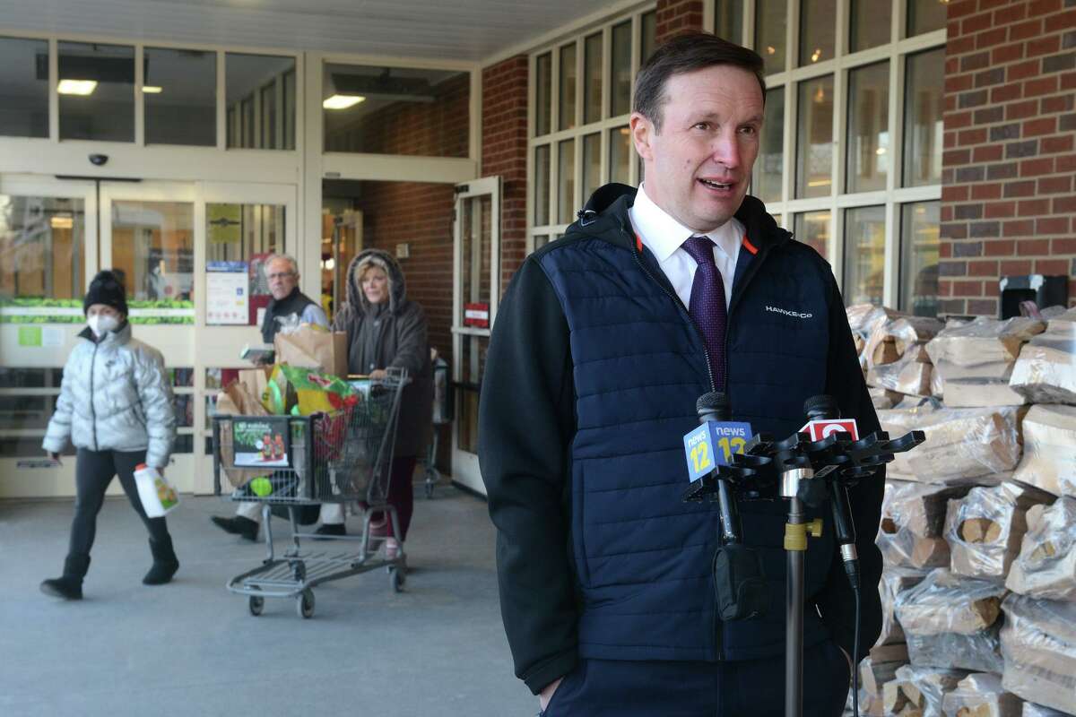 U.S. Sen. Chris Murphy speaks outside the Stop & Shop in Town Hall Shopping Plaza following a tour with the supermarket’s management, in Trumbull, Conn. Jan. 25, 2022.