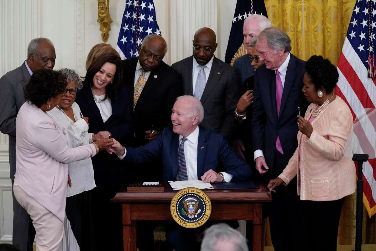 President Biden hands a pen to Rep. Barbara Lee, D-Oakland, after signing the Juneteenth National Independence Day Act on June 17. Lee told The Chronicle on Wednesday that she’s confident Biden will fulfill his pledge to nominate a Black woman to the Supreme Court.