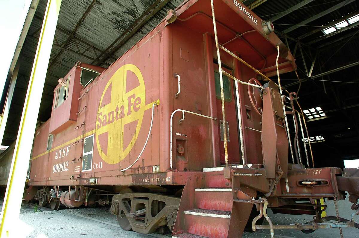 The BNSF Railway donated an obsolete caboose to the Port of Beaumont, which intends to renovate the exterior and put it on display near the port's iconic ship's propeller which is near the main gate. The caboose once was a common site on American railroads as a haven for off-duty train crews and as a lookout post to ensure safety. In the mid-1980s, cabooses were uncoupled from trains as new labor agreements took effect and other more technologically advanced safety measures replaced them. The donated caboose is currently sitting under a shed at the port and could be moved into position by next August. John Roby, the port's customer service director, is looking out the upper viewing window. .Dave Ryan/The Enterprise