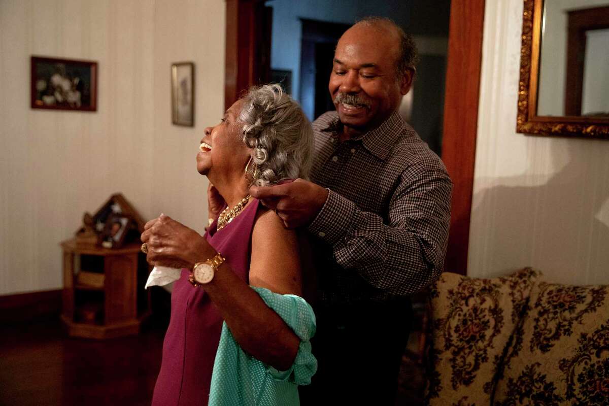 David Smith helps his mother, Barbara Jean Smith get ready for church service in her East side home. Barbara Jean has lived in the same house since the 70?•s when she and her husband bought it. They raised their children there and host many family events there.