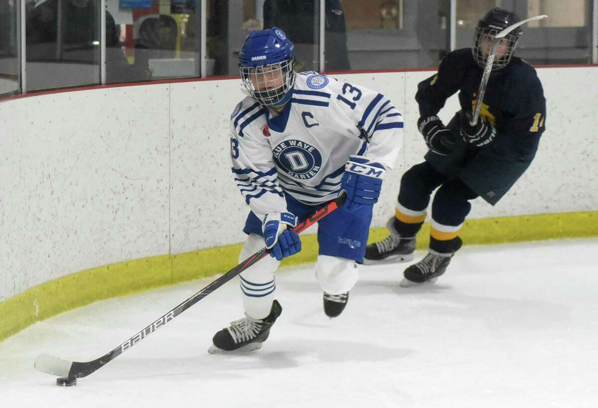 Darien’s Ceci Stein (13) skates with the puck during a girls ice hockey game against Simsbury at the Darien Ice House on Wednesday.