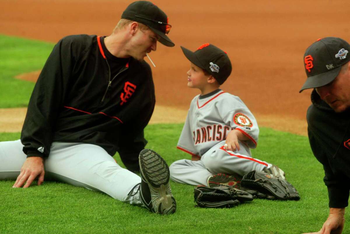 GIANTS17-C-16OCT02-MT-MK.jpg---Giant Jeff Kent and his son Hunter stretch with the rest of the team during the team workout at Edison Field October 17, 2002. The San Francisco Giants play the Anaheim Angels in the World Series with games one and two being in Anaheim. Mike Kepka/San Francisco Chronicle