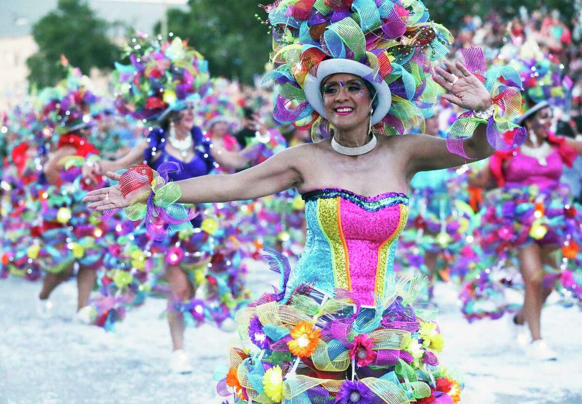 Las Charangas dancers move down Broadway in the Fiesta Flambeau Parade on April 27, 2019.