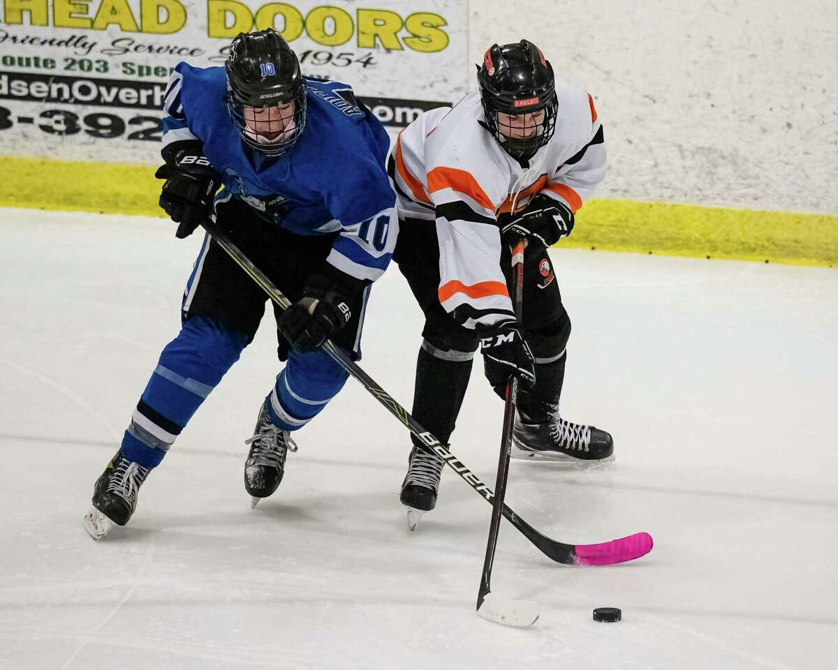 Adirondack sophomore Matt Perrotte and Bethlehem freshman Dylan McInerney battle for the puck during a Section II game at the Bethlehem Area YMCA on Wednesday, Jan. 26, 2022. (Jim Franco/Special to the Times Union)