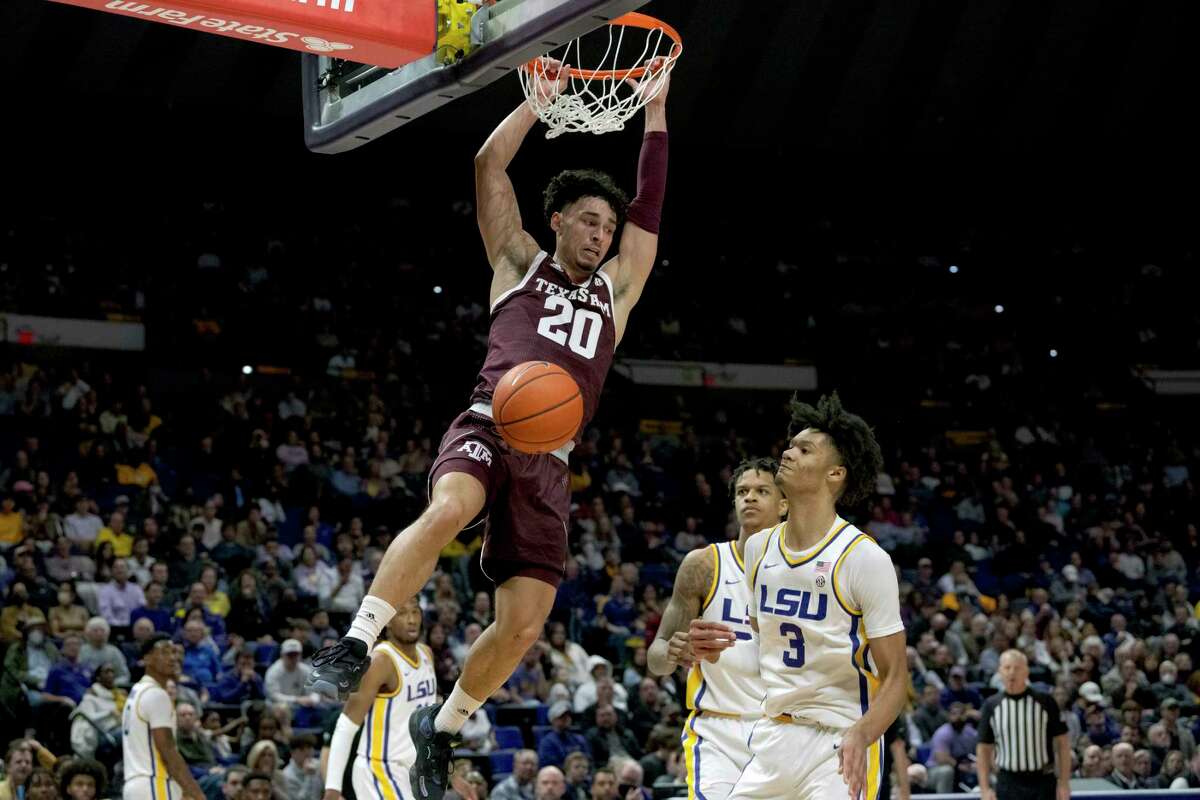 Texas A&M guard Andre Gordon (20) dunks against LSU forward Alex Fudge (3) during the first half of an NCAA college basketball game in Baton Rouge, La., Wednesday, Jan. 26, 2022. (AP Photo/Matthew Hinton)