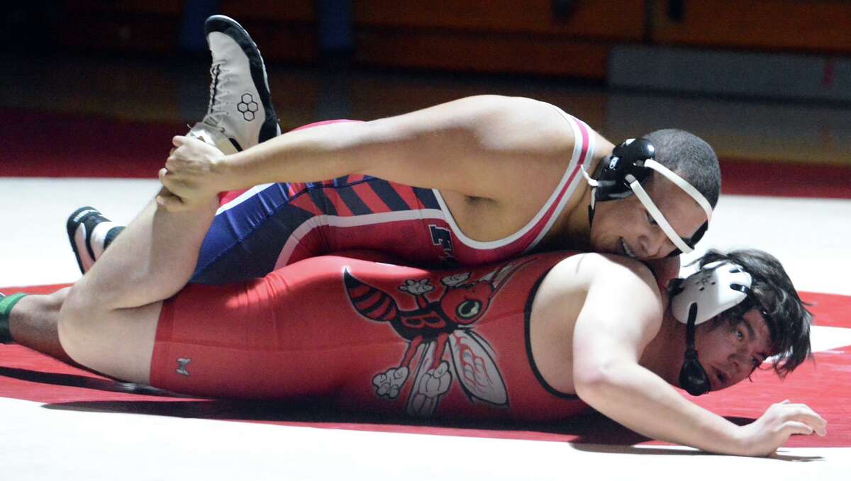 Jason Cruz of Foran grabs the foot of Bill Dellacamera of Branford during the 285-pound bout on Wednesday.