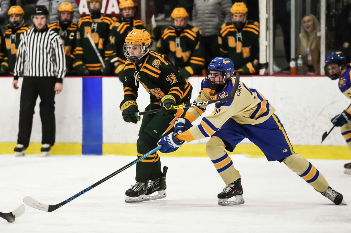 Midland's Cole Carpenter and Dow's Jack Wolohan pursue the puck during their game Wednesday, Jan. 26, 2022 at Midland Civic Arena. Carpenter scored the game's lone goal in Midland's 1-0 victory over DeWitt in a Division 1 state quarterfinal on Saturday, March 5, 2022.