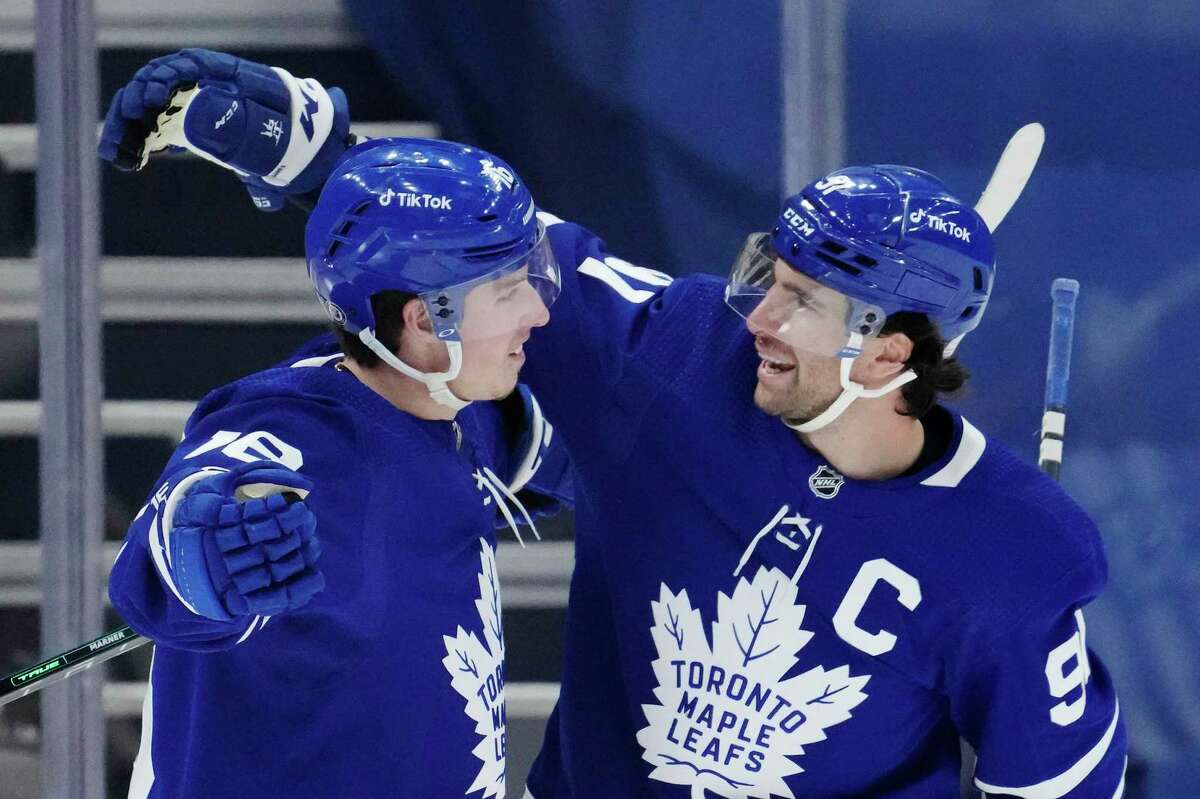 Toronto Maple Leafs' Mitchell Marner (16) celebrates his goal with teammate John Tavares (91) after scoring a goal against the Anaheim Ducks during the first period of an NHL hockey game in Toronto on Wednesday, Jan 26, 2022. (Frank Gunn/The Canadian Press via AP)