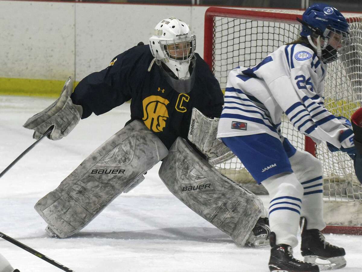 Simsbury goalie Kaitlyn O'Brien keeps her eyes on the puck during a girls ice hockey game against Darien at the Darien Ice House on Wednesday, Jan. 26, 2022.