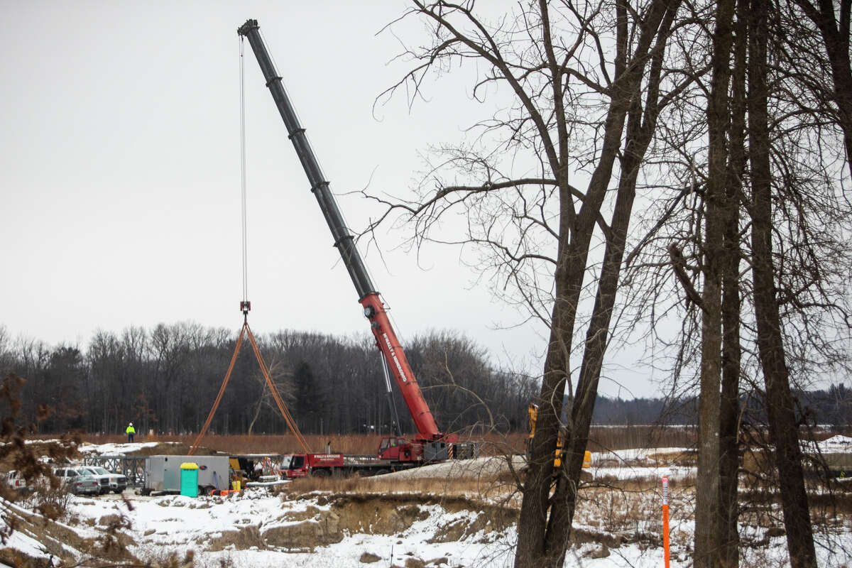 Construction work continues on a temporary bridge near Sanford Dam Thursday, Jan. 27, 2022.