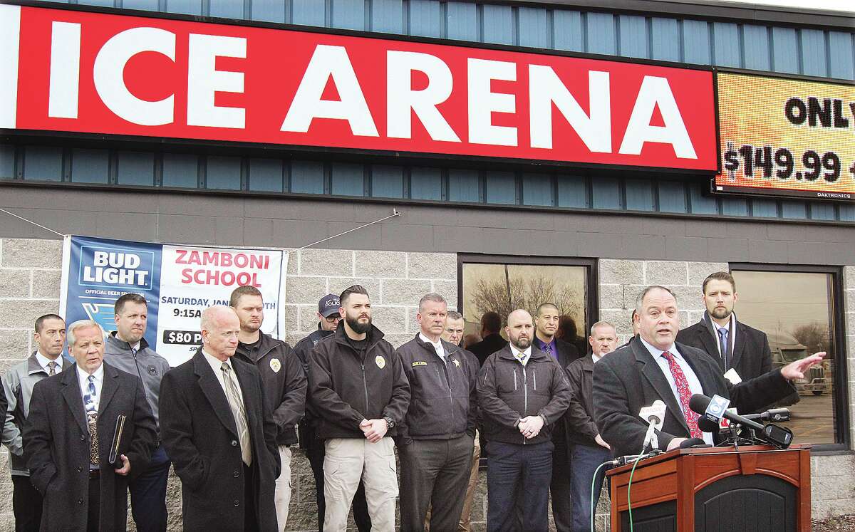 John Badman|The Telegraph East Alton Police Chief Scott Golike, right, talks at a press conference Thursday in front of the East Alton Ice Arena where two people were injured in a shooting on the parking lot Saturday night. Standing with police from across the area, and other officials, it was announced that charges had been filed against two individuals who are now in custody.