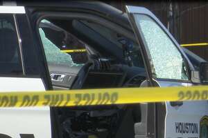 Shattered windows are seen on a Houston police cruiser after three cops were shot in Third Ward on Thursday, Jan. 27, 2022. 